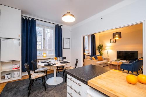 a kitchen and living room with a table and chairs at Prime City Escape 45 Square Meters in Helsinki