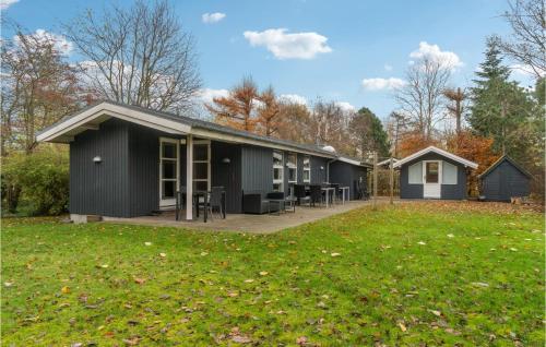 a large black building with a grass yard at 3 Bedroom Cozy Home In Gørlev in Gørlev