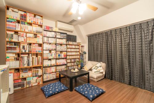 a library with a table in a room with bookshelves at 錦糸町 in Tokyo