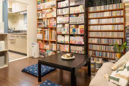 a library with a table and book shelves with books at 錦糸町 in Tokyo