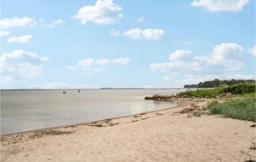 a beach with sand and water and clouds in the sky at 2 Bedroom Beach Front Home In Sjølund in Sjølund
