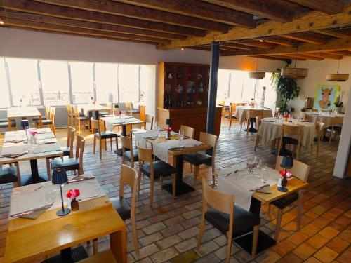 a restaurant with tables and chairs in a room at Auberge de l'Union in Arzier