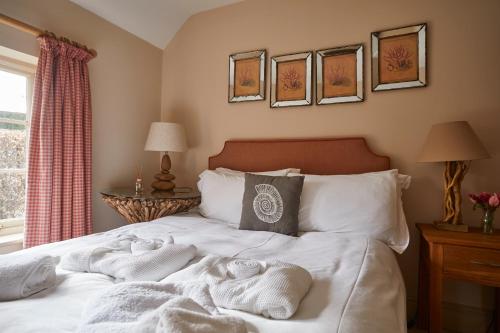 a bedroom with a bed with towels on it at The Duncombe Arms in Ellastone