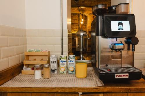 a kitchen counter with a coffee maker on a counter top at Wombat's City Hostel London in London