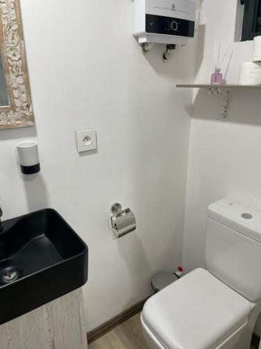 a white bathroom with a sink and a toilet at Sam & Chlo Studio & Appartment - Grand Baie - Mauritius in Grand Baie