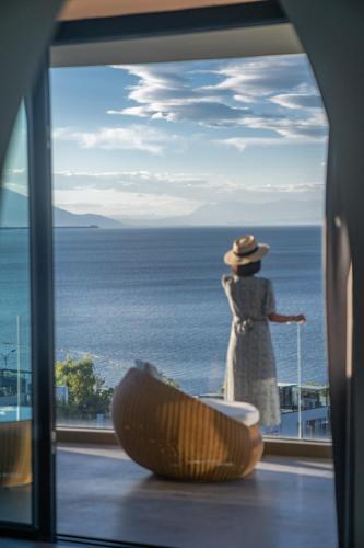 a woman standing on a balcony looking out at the ocean at Anyu Aranya Lake View Hotel in Dali