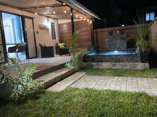 a patio with a fire pit in the back of a house at Sam & Chlo Studio & Appartment - Grand Baie - Mauritius in Grand Baie