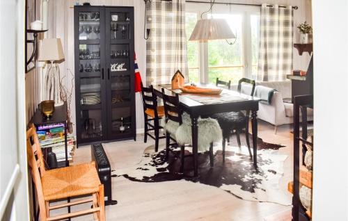 a dining room with a black table and chairs at 3 Bedroom Nice Home In Gol in Gol