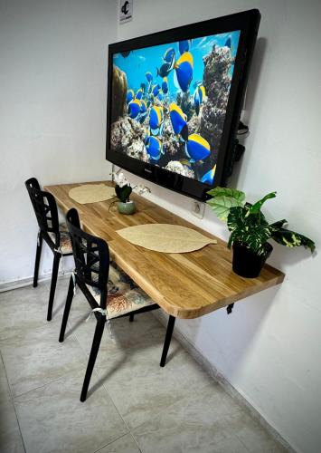 a television sitting on top of a wooden table at MAYA Studio in Eilat