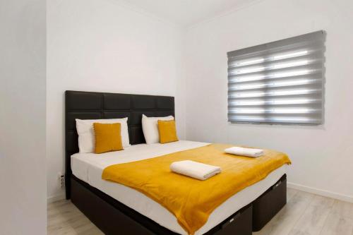 a bedroom with a large bed with two towels on it at Jay Paradise in Santa Cruz