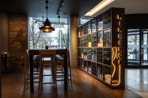 a tasting room with a bar and a wine cellar at Novotel Vilnius Centre in Vilnius