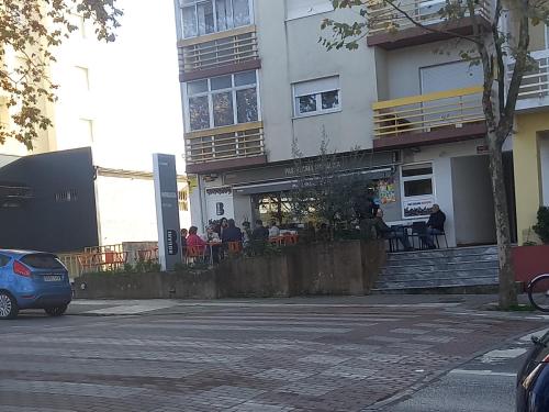 a group of people sitting outside of a building at Vista para a serra in Bragança