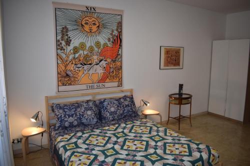 a bedroom with a bed and a painting on the wall at Vacanze Romane in Rome