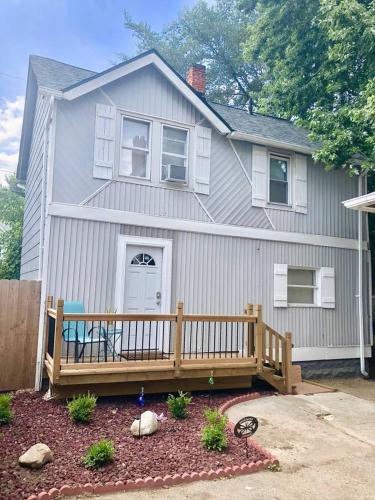 a house with a wooden deck in front of it at The House Hotels - W45th Backhouse in Cleveland
