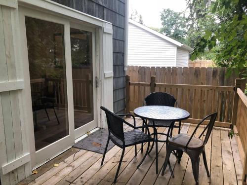 a patio with a table and chairs on a deck at The House Hotels - W45th Backhouse in Cleveland