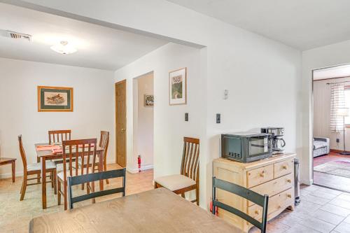 a kitchen and dining room with a table and a tv at Quiet Catskill Getaway with Fire Pit - Near Hiking! in Catskill