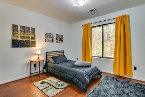 a bedroom with a bed and a window with yellow curtains at Quiet Catskill Getaway with Fire Pit - Near Hiking! in Catskill