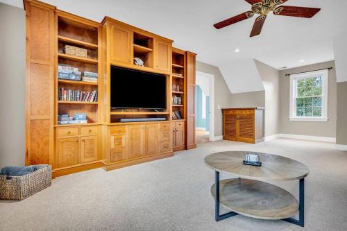 a large living room with a tv and a table at Lakefront Moose Pond Retreat in Denmark