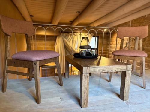 zwei Stühle und ein Tisch mit einer Lampe drauf in der Unterkunft Mitu in Purmamarca