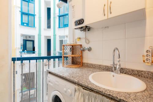 a bathroom with a sink and a balcony at RESORT BEACH VALENCIA in Valencia