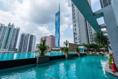 a pool in the middle of a city with tall buildings at No Other Fee #Swiss Garden Residences by The Boston House #Bukit Bintang in Kuala Lumpur
