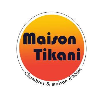 a yellow and orange circle with the words niagara tikiani at Maison Tikani in Cotonou