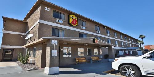 a front view of a hotel with a car parked in front at Super 8 by Wyndham Lake Havasu City in Lake Havasu City