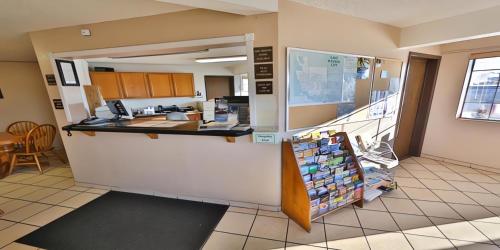 a lobby of a hospital with a counter and a kitchen at Super 8 by Wyndham Lake Havasu City in Lake Havasu City