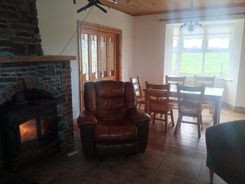 a living room with a chair and a fireplace at Global Guest Ireland in Williamstown