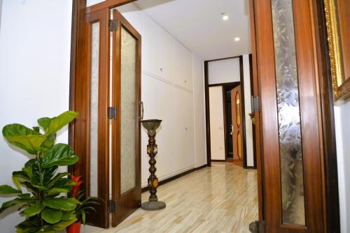 a hallway with a door and a plant on the floor at Punto Felice Riviera - Centro Città Lungomare Caracciolo in Naples