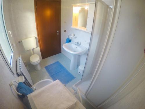 a bathroom with a sink and a toilet and a shower at Residence Soleil - Agenzia Cocal in Caorle