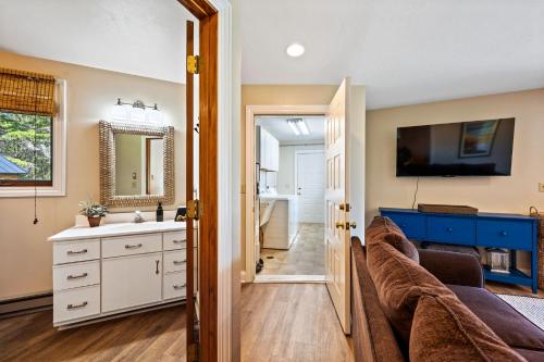 a living room with a couch and a sink at The Goat and Cherry - Dogs, Fire Pit & Hot Tub, Escape to Sister Bay! in Sister Bay