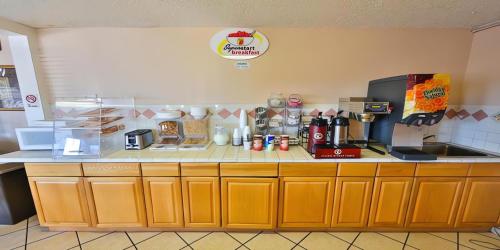 a kitchen with a counter with a coffee maker at Super 8 by Wyndham Lake Havasu City in Lake Havasu City