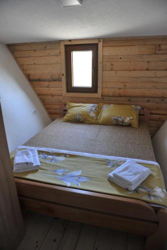 a large bed in a room with a window at Androv kutak in Andrići