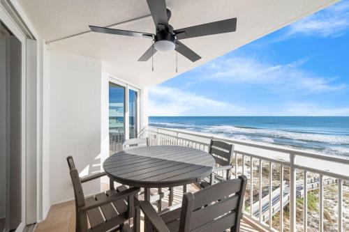 a table and chairs on a balcony with the ocean at SeaSpray East 624-Gulf Front in Pensacola