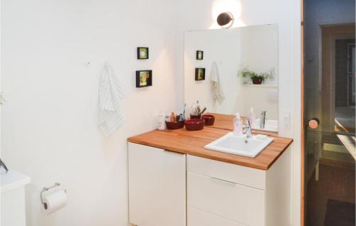 a bathroom with a sink and a mirror at Holiday Home Strandskadevej Ørsted Xi in Kare