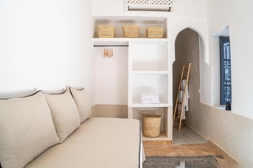 a living room with a couch and shelves at Riad COPAH in Marrakech