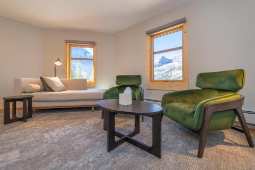 a living room with a couch and a chair and a table at The Lodge at Bow Lake in Lake Louise