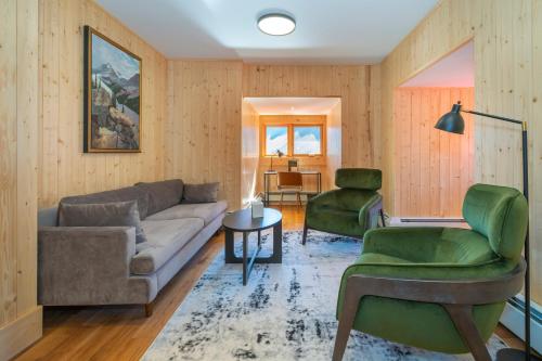 a living room with a couch and two chairs at The Lodge at Bow Lake in Lake Louise