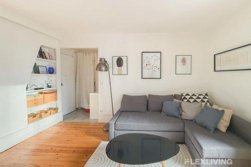 un salon avec un canapé et une table dans l'établissement Flexliving - One bedroom - Houdon, à Paris