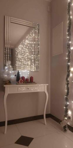 a dressing table with a mirror and christmas lights at Villa6 in Pobierowo