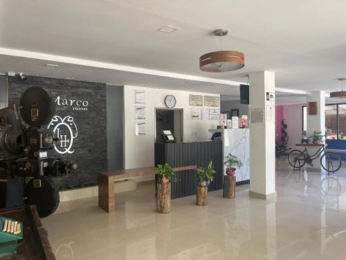 a lobby with a coffee shop with a table and a refrigerator at Hotel D Marco Exxpres in Palenque