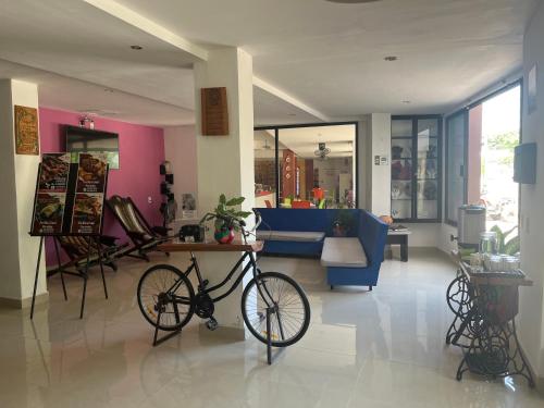 a bike parked in a room with a living room at Hotel D Marco Exxpres in Palenque