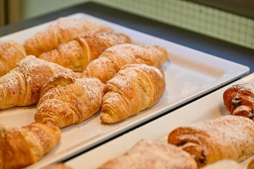 a bunch of croissants and other pastries on trays at Albergo Atlantic in Ischia