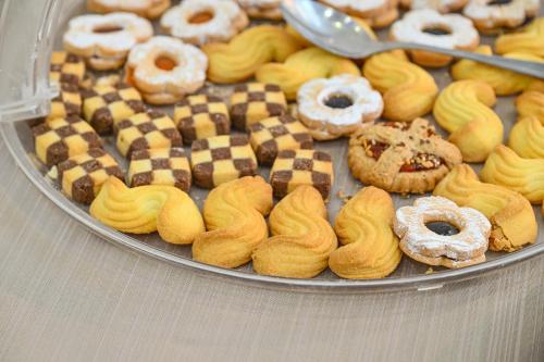 a tray of different types of donuts on a table at Albergo Atlantic in Ischia