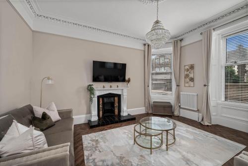 a living room with a couch and a fireplace at Willowbank in Broughty Ferry
