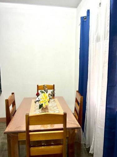 a dining room table with a vase of flowers on it at Miravalles Country House in Guayabal