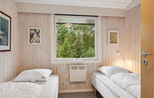 two beds in a room with a window at Stunning Home In Fårvang With Wifi in Fårvang