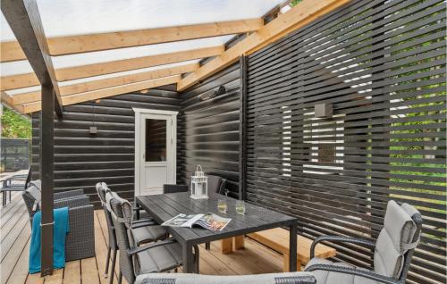 a patio with a table and chairs on a deck at Holiday Home Jacobslystvej Gilleleje Vi in Gilleleje