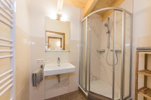 a bathroom with a shower and a sink at Berggasthof Christernreith in Maria Alm am Steinernen Meer